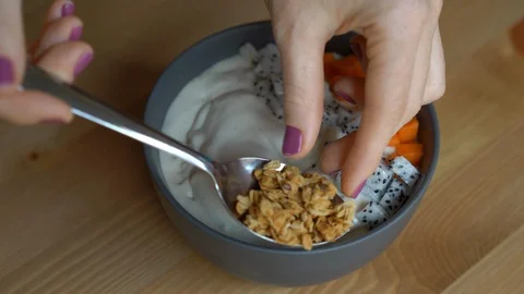 Closeup shot of a process of making a smoothie bowl with papaya, dragon fruit Stock Footage 108068939
