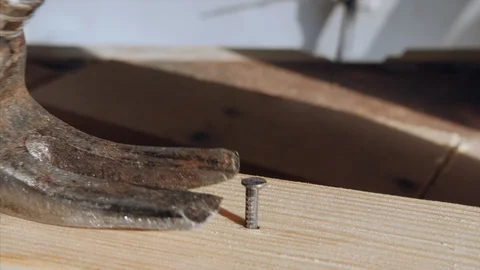 Closeup shot of pulling out the nail from wood Stock Footage 115249796