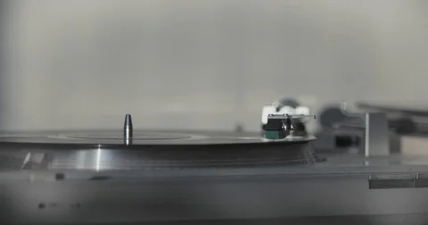 Closeup shot of a record spinning on a turntable in slow motion Stock Footage 120699795
