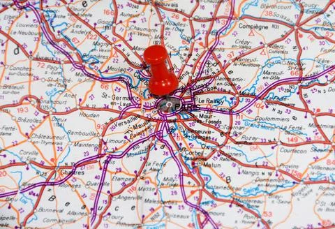 Closeup shot of a red pushpin on the map of Paris city, France Stock Photos