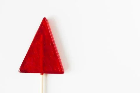 Closeup shot of a red triangular lollypop on a white background Stock Photos