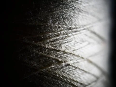 Closeup shot of a rolled knitting string in the dark 库存照片