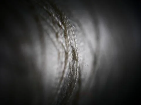 Closeup shot of a rolled knitting string in the dark 库存照片