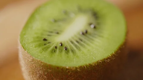Closeup Shot Of Rotating Kiwi Slice On Table Stock Footage 86119487