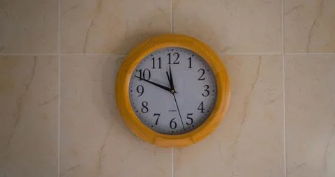 Closeup shot of a round clock on the wall Stock Photos