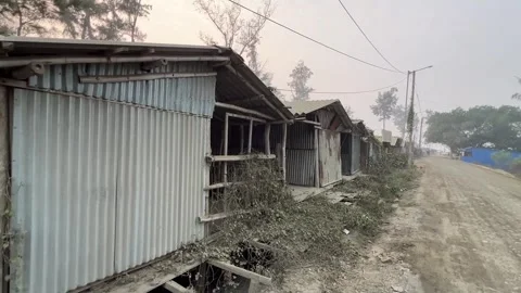 Closeup shot of rows of make shift aluminum cottages near a vacant road Stock Footage 261016703