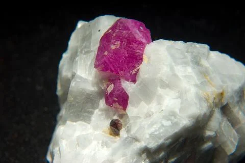 Closeup shot of a Ruby stone isolated on a black background Stock Photos