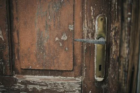 Closeup shot of a rusty handle on an old wooden door Photos