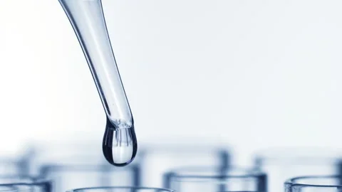 Closeup shot of scientist dripping liquid into test tube with rotating Stock Footage 138641371