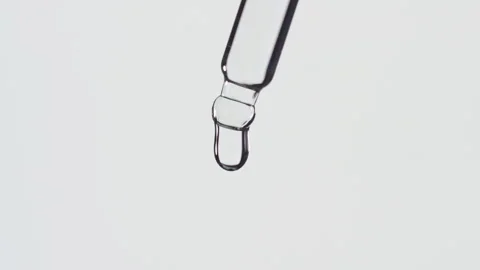 Closeup shot of scientist dripping liquid on white background. Stock Footage 338444427