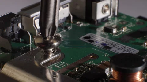 Closeup shot of a screw being inserted into a hard drive. Selective focus. Stock Footage 211894088