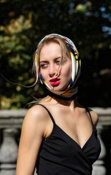 Closeup shot of seductive model with red lips wearing shawl and black dress p Stock Photos