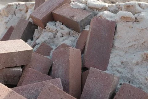Closeup shot of several rectangular stones on a pile of sand 库存照片