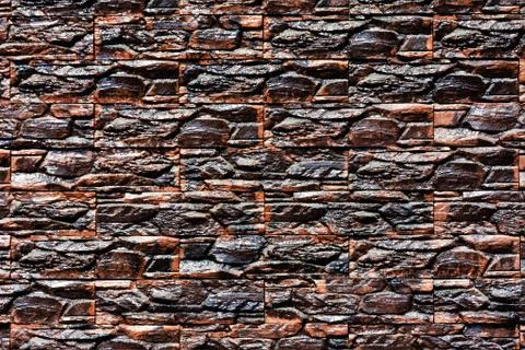 Closeup shot of several rectangular stones with deep dark brown textures 写真素材