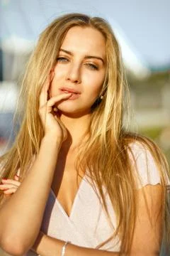 Closeup shot of sexy blonde model with perfect skin and nude makeup posing at Stock Photos