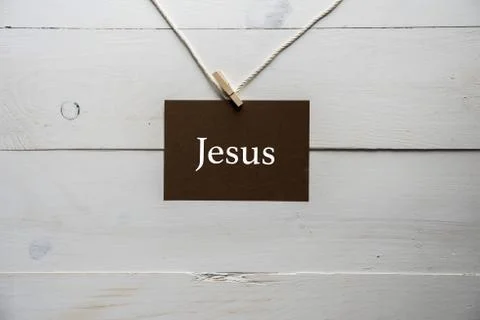 Closeup shot of a sing attached to a string with Jesus written on it Stock Photos
