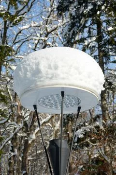 Closeup shot of a snow stack on the circular lantern in the park Stockfoto's