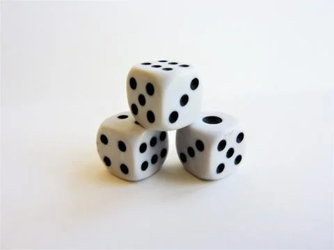 Closeup shot of a stack of dice isolated on a white background Stock Photos