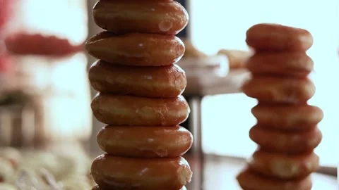 Closeup Shot of Stack of Golden Sugary Glazed Ring Donuts part of Wedding Stock Footage 166503867