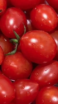 Closeup shot of a stack of juicy red cherry tomatoes. Stock Photos