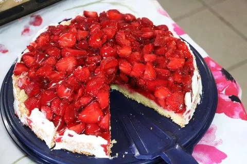 Closeup shot of a strawberry pie that is missing one slice from the tray Stock Photos