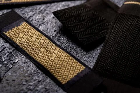 Closeup shot of strips of patterned black and gold fabric for fashion design 스톡 사진