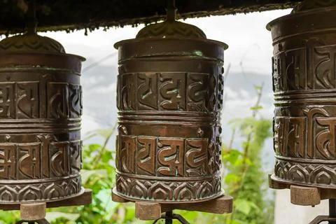 Closeup shot of three old Prayer wheels at Tibetan Buddhist Monastery at Si.. Stock Photos