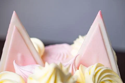 Closeup shot of triangular sweet cake decorations resembling cat ears 스톡 사진