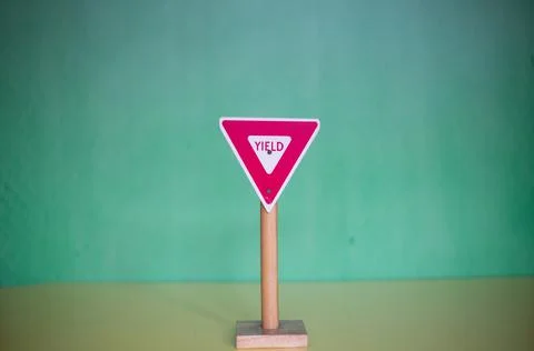 Closeup shot of a triangular "Yield" sign on a blurred background 写真素材