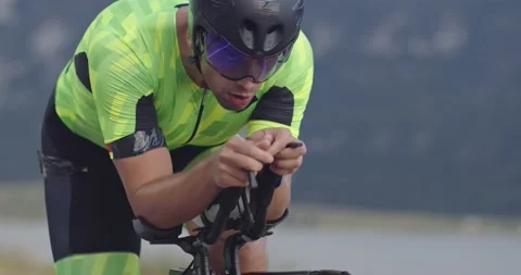 Closeup shot of triathlon sportsman athlete cyclist riding professional racing Stock Footage