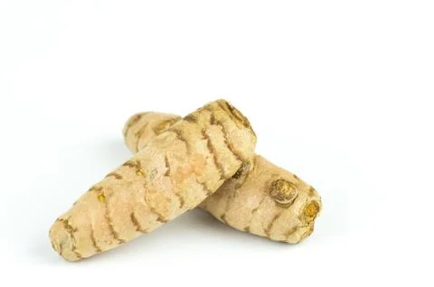 Closeup shot of tumeric roots isolated on a white background Stock Photos