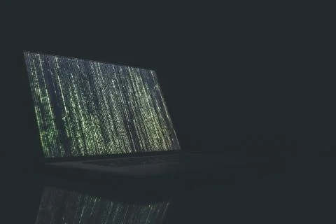 A closeup shot of a turned on laptop with a coding showing on the screen on a Foto stock