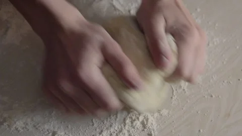 Closeup shot of two hands of young woman kneading dough Stock Footage 239793322