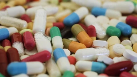 Closeup shot of various medication pills spinning Stock Footage 97054048