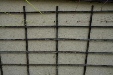 Closeup shot of a wall with rectangle patterned wood and colorful strings Stock Photos