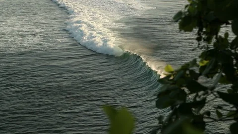 Closeup shot of waves rolling towards Bali from a Cliff, Slowmotion with a Stock Footage 99856897