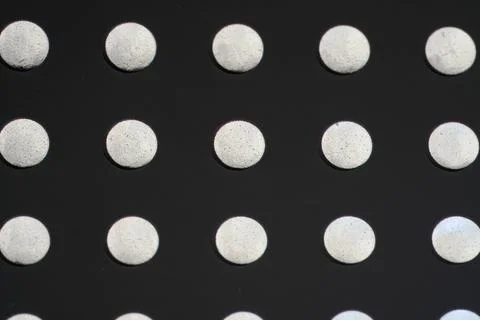 Closeup shot of white circle elements on a black background Stock Photos