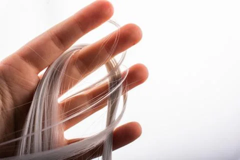 Closeup shot of white smooth string wrapped around fingers Stock Photos