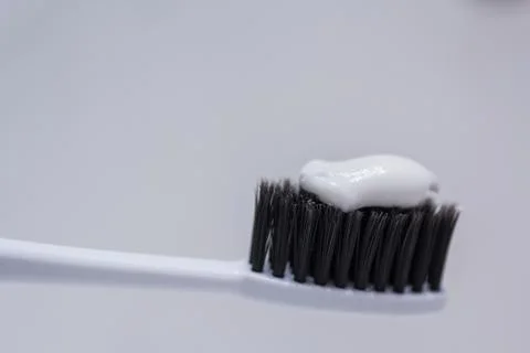 Closeup shot of white toothbrush with toothpaste on it Foto stock