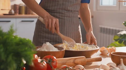 Closeup shot of woman hands preparing dough in the kitchen flooded with sunlight Stock Footage 235548784