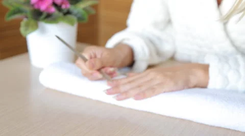 Closeup shot of a woman using a cuticle pusher to give a nail manicure. Nail Stock Footage