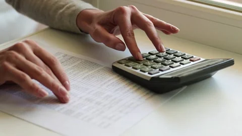 Closeup shot of woman’s fingers using calculator. 스톡 동영상 150236180