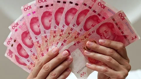 Closeup shot of woman's hands and Chinese Yuan (CNY) banknotes. Stock Footage 307963139
