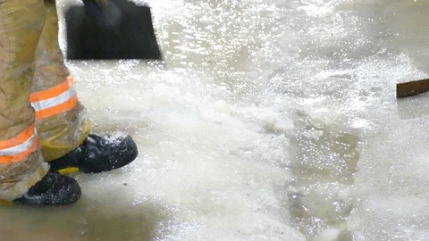 Closeup of the shovel of a fireman while it is breaking ice to let water through Stock Footage 102486606