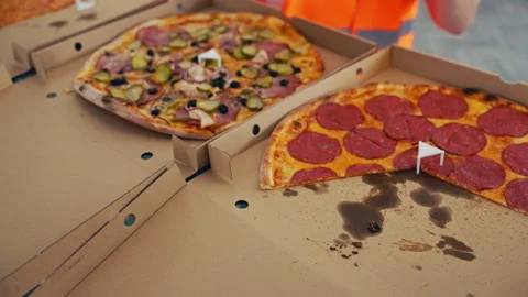A closeup shows a hand grabbing a slice of pepperoni pizza, filled with Video stock 276674274