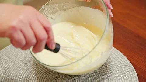 Closeup Shows Hands Mixing Smooth Cake Batter With Whisk During Home Baking Prep Stock Footage 344007904