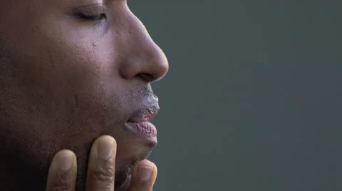 Closeup side portrait of a black fired businessman sitting alone and sad  Stock Footage 58330771