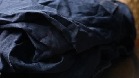 Closeup Side View of Blue Jeans Fabric Shirt Rotating Stock Footage 329341477