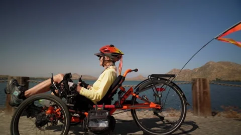 Closeup side view of elderly senior woman riding recumbent e-bike electric Stock Footage 243276427