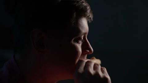 Closeup side view of face of handsome hungry man eating slice of tasty pizza on Stock Footage 263526742